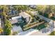 Aerial view of a modern home with a metal roof, manicured landscaping, and fenced yard at 3026 Mayflower St, Sarasota, FL 34231