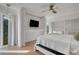 Bright bedroom with a modern ceiling fan, large windows, and minimalist decor for a serene retreat at 3026 Mayflower St, Sarasota, FL 34231