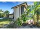 Lush greenery and palm trees accent this modern home's exterior, enhancing its curb appeal at 3026 Mayflower St, Sarasota, FL 34231