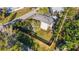 Aerial view of the modern home with a well-manicured lawn and a wooden fence surrounded by greenery at 3026 Mayflower St, Sarasota, FL 34231