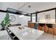 Modern kitchen with white counters, wood cabinets, island and decorative plant at 3026 Mayflower St, Sarasota, FL 34231