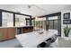 Modern kitchen with island, bar seating, white counters and view to outside dining area at 3026 Mayflower St, Sarasota, FL 34231