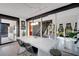 Bright, modern kitchen with white island, sleek lighting and black window frames at 3026 Mayflower St, Sarasota, FL 34231