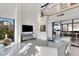 Bright living room featuring floor-to-ceiling windows, modern decor, and staircase to loft at 3026 Mayflower St, Sarasota, FL 34231