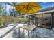 Secluded patio boasts a lounge area, a dining set, and seamless indoor-outdoor flow to the home at 3026 Mayflower St, Sarasota, FL 34231