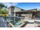 Backyard pool and spa with a screened lanai and modern architecture at 3026 Mayflower St, Sarasota, FL 34231