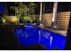 Backyard pool and spa with lounge chairs, enhanced with blue night lighting at 3026 Mayflower St, Sarasota, FL 34231