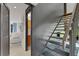 Modern staircase leading up from a living space, featuring sleek design with grey tones and stone details at 3026 Mayflower St, Sarasota, FL 34231