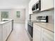 Well-lit kitchen featuring modern appliances, sleek countertops, and ample cabinet space at 3200 California Ter, North Port, FL 34291