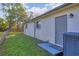 Backyard of house with a partial view of the side of the house and AC unit at 3311 19Th E St, Bradenton, FL 34208