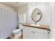 Bathroom featuring a vanity with white cabinets, decorative mirror and subway tile backsplash at 3311 19Th E St, Bradenton, FL 34208