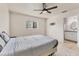 Spacious bedroom with tile flooring, a ceiling fan, and access to the ensuite bathroom at 3311 19Th E St, Bradenton, FL 34208