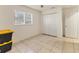 Bright bedroom with closet, tile flooring, and a window with blinds for natural light at 3311 19Th E St, Bradenton, FL 34208