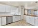 Bright and airy kitchen with stainless appliances, white cabinets and a large window at 3311 19Th E St, Bradenton, FL 34208