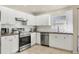 Modern kitchen with stainless steel appliances, white cabinets, and subway tile backsplash at 3311 19Th E St, Bradenton, FL 34208