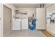 Laundry room with washer, dryer, water heater, and shelving for storage at 3311 19Th E St, Bradenton, FL 34208