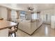 Open-concept living room featuring tile floors, a ceiling fan, and a neutral sectional couch at 3311 19Th E St, Bradenton, FL 34208