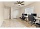 Office with a ceiling fan, featuring tile flooring and multiple desks and monitors at 3311 19Th E St, Bradenton, FL 34208