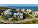 Aerial view of buildings surrounding a pond, with water in the background, and trees at 3404 79Th Street W Cir # 301, Bradenton, FL 34209