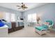 Bright bedroom with a coastal theme, includes ceiling fan, carpet, a desk, and a chair at 3404 79Th Street W Cir # 301, Bradenton, FL 34209