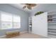 Bedroom featuring a murphy bed, built-in bookcase, large window, and carpet at 3404 79Th Street W Cir # 301, Bradenton, FL 34209