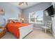 Cozy bedroom with bright orange bedding, a white bed frame, and a ceiling fan at 3404 79Th Street W Cir # 301, Bradenton, FL 34209