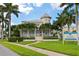 Clubhouse exterior with palm trees and sidewalk at 3404 79Th Street W Cir # 301, Bradenton, FL 34209