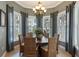 Dining area with round table and wicker chairs under a chandelier, surrounded by windows and curtains at 3404 79Th Street W Cir # 301, Bradenton, FL 34209