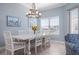 Bright dining room features a modern chandelier, six-seat table, and beach-themed artwork at 3404 79Th Street W Cir # 301, Bradenton, FL 34209