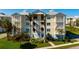 Coastal condo exterior with palm trees and white staircases at 3404 79Th Street W Cir # 301, Bradenton, FL 34209