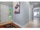 Hallway with blue-grey walls, artwork, and doors at 3404 79Th Street W Cir # 301, Bradenton, FL 34209