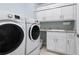 Bright laundry room features modern washer and dryer, with storage cabinets and sink, plus granite counters at 3404 79Th Street W Cir # 301, Bradenton, FL 34209