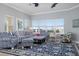 Living area featuring striped couch, patterned chairs, and a colorful parrot painting at 3404 79Th Street W Cir # 301, Bradenton, FL 34209