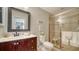 Well-lit bathroom featuring a glass-enclosed shower, vanity with granite countertop, and modern fixtures at 3530 Flores Ave, Sarasota, FL 34239