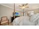 Inviting bedroom featuring a four-poster bed, ceiling fan, and TV, designed for ultimate comfort at 3530 Flores Ave, Sarasota, FL 34239