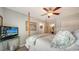 Bedroom features a ceiling fan, four poster bed, and neutral decor at 3530 Flores Ave, Sarasota, FL 34239