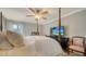 Bedroom boasts a four-poster bed, ceiling fan, tv, and neutral colors at 3530 Flores Ave, Sarasota, FL 34239