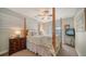 Bedroom features a ceiling fan, four poster bed, and neutral decor at 3530 Flores Ave, Sarasota, FL 34239