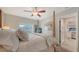 Bedroom features a ceiling fan, four poster bed, and neutral decor at 3530 Flores Ave, Sarasota, FL 34239