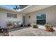 Relaxing patio with paver flooring, stylish furniture, potted flowers, and glass block window offering both privacy and light at 3530 Flores Ave, Sarasota, FL 34239