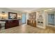 Stylish foyer with a wood accent cabinet, mirror, bench seating, and tile flooring, creating an inviting entrance at 3530 Flores Ave, Sarasota, FL 34239