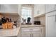 Close-up of a kitchen counter featuring a coffee maker, knife block, and white cabinets at 3530 Flores Ave, Sarasota, FL 34239