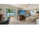 Bright living room with double doors leading to a brick patio and lush greenery at 3530 Flores Ave, Sarasota, FL 34239