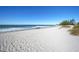 Beautiful beach landscape with clear sky, blue ocean, and white sand at 380 Three Lakes Ln # B, Venice, FL 34285