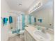 Bright bathroom featuring decorative shower curtain, and a large mirror at 4061 Crockers Lake Blvd # 2611, Sarasota, FL 34238