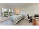 Bright bedroom with natural light, features a cozy bed and work desk at 4061 Crockers Lake Blvd # 2611, Sarasota, FL 34238