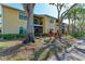 Charming condo exterior surrounded by mature trees, lush landscaping, and inviting balcony at 4061 Crockers Lake Blvd # 2611, Sarasota, FL 34238