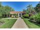 Exterior view of community center featuring a well-manicured lawn and lush landscaping at 4061 Crockers Lake Blvd # 2611, Sarasota, FL 34238