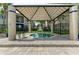 Covered hot tub with shade structure surrounded by landscaping, offering a relaxing and private spa experience at 4061 Crockers Lake Blvd # 2611, Sarasota, FL 34238