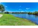 Scenic lake view from the community green space with lush grass and waterfront walking path at 4061 Crockers Lake Blvd # 2611, Sarasota, FL 34238